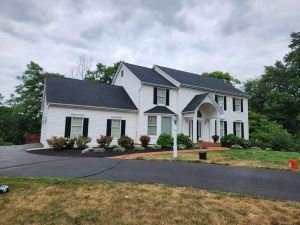 New asphalt shingle roof installed on a colonial-style home by Birds Eye Roofing
