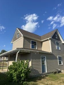 Home with new siding and a freshly installed roof, completed by Birds Eye Roofing