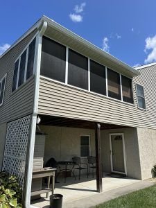 Screened porch and deck with new siding and gutters, completed by Birds Eye Roofing