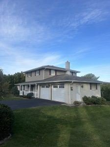 Two-story home with completed roofing and siding work by Birds Eye Roofing